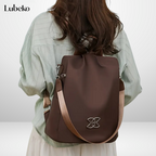 Brown anti theft travel bag worn as a backpack