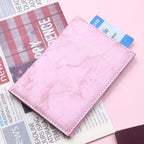 Marbelle passport holder open with organised travel documents