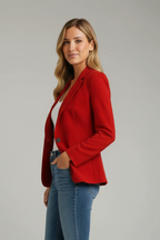 Model in a red womens blazer jacket with hand in pocket, side view