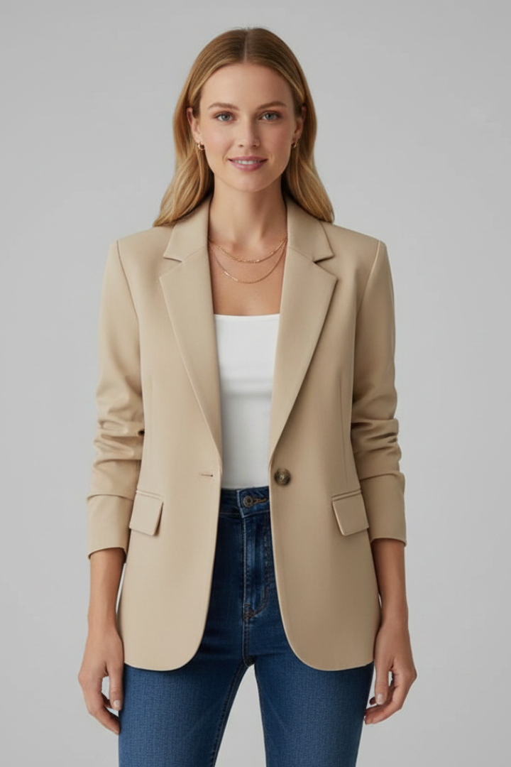 Model wearing a beige womens blazer jacket with a white top