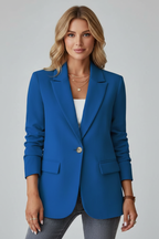 Model wearing a blue womens blazer jacket with a white top