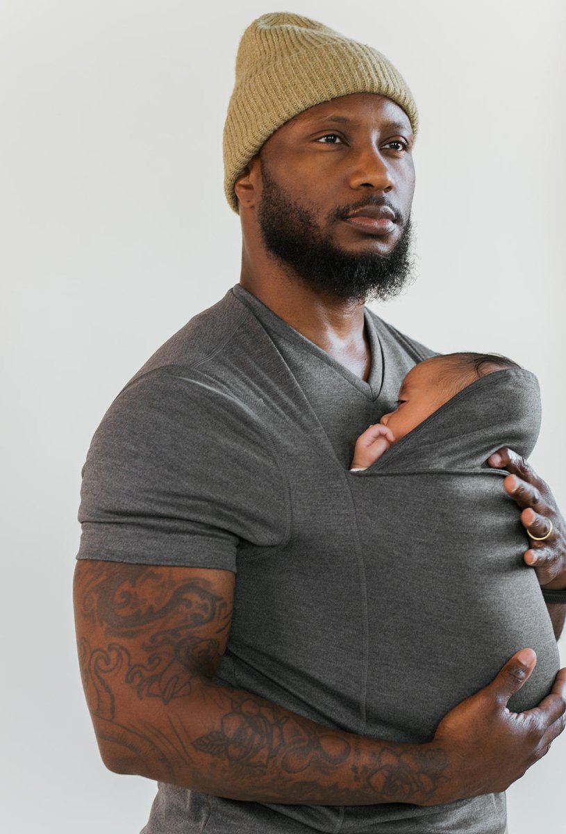 Man wearing the Grey CuddleNest kangaroo shirt with baby supported