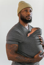 Man wearing the Grey CuddleNest kangaroo shirt with baby supported