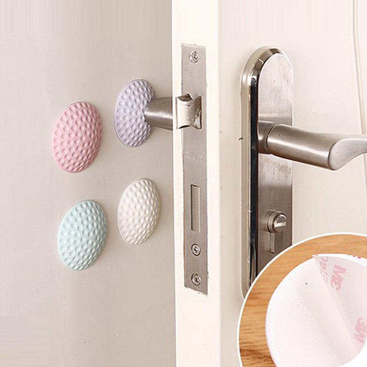 Round rubber wall protector cushioning a door handle