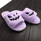 Purple plush Halloween slippers on a dark wooden floor