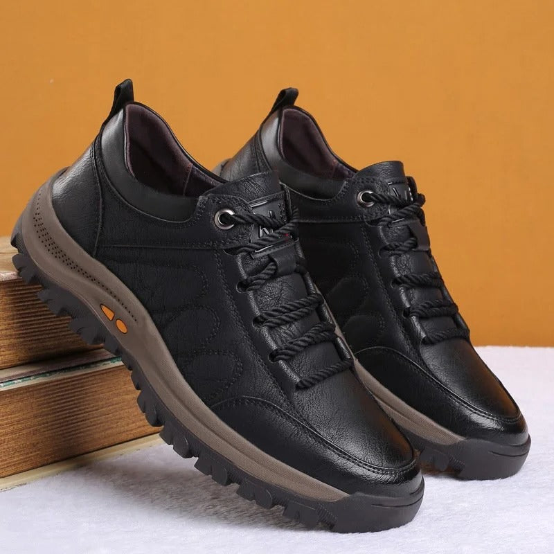 Men's black arch support shoes displayed in a studio