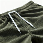 Green swim shorts drawcord and elastic waist, close-up