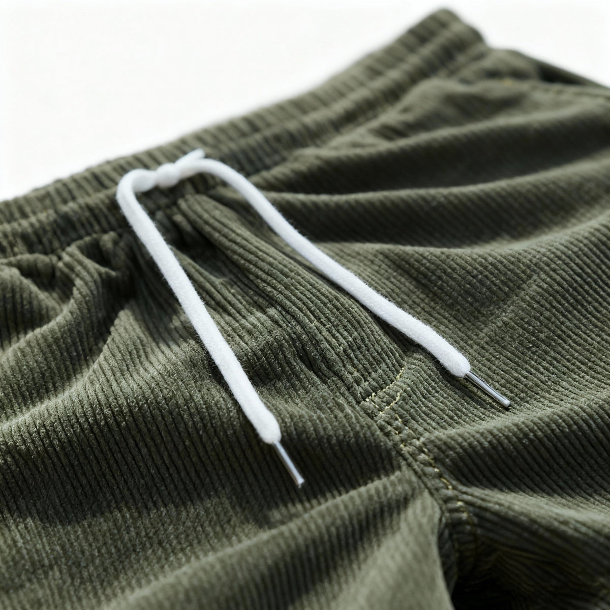Green swim shorts drawcord and elastic waist, close-up