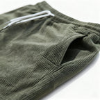 Green swim shorts side pocket, close-up
