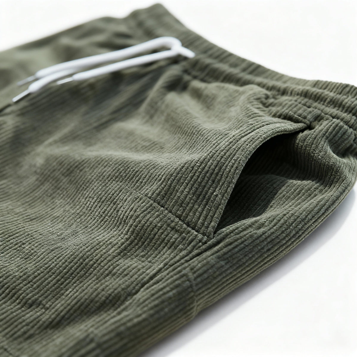 Green swim shorts side pocket, close-up